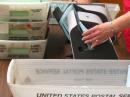 After this machine opens the sealed envelopes, the ballots are removed and counted by ARRL assistants.